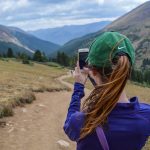 woman taking photo of mountain